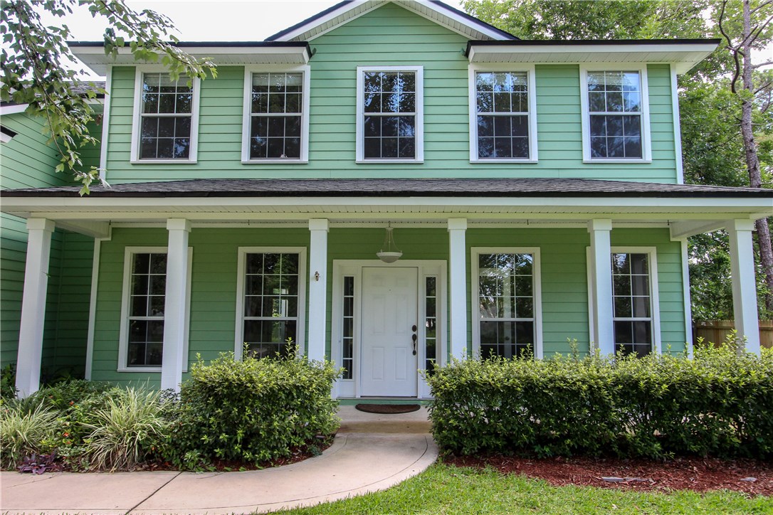 2965 Pinedale Road Fernandina Beach, FL 32034 - Photo 1 of 35 front view of a brick house with large windows and a yard