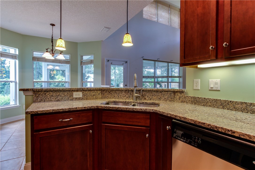2965 Pinedale Road Fernandina Beach, FL 32034 - Photo 14 of 35 a kitchen with granite countertop stainless steel appliances sink and cabinets