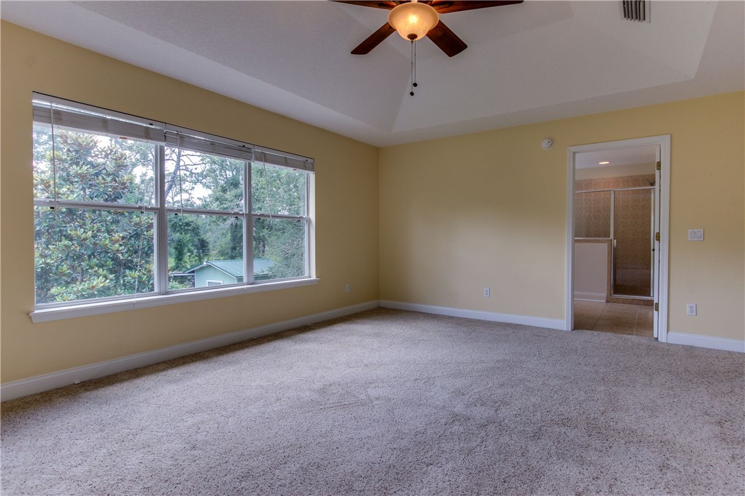 2965 Pinedale Road Fernandina Beach, FL 32034 - Photo 16 of 35 an empty room with a ceiling fan and window