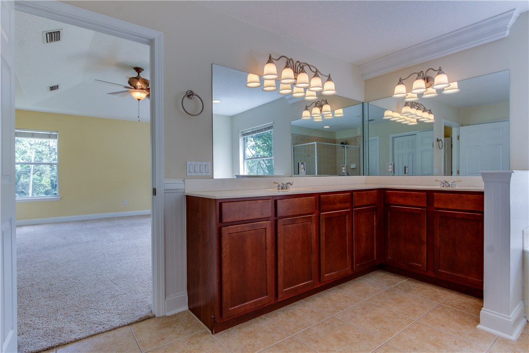 2965 Pinedale Road Fernandina Beach, FL 32034 - Photo 18 of 35 a bathroom with a double vanity sink and a mirror