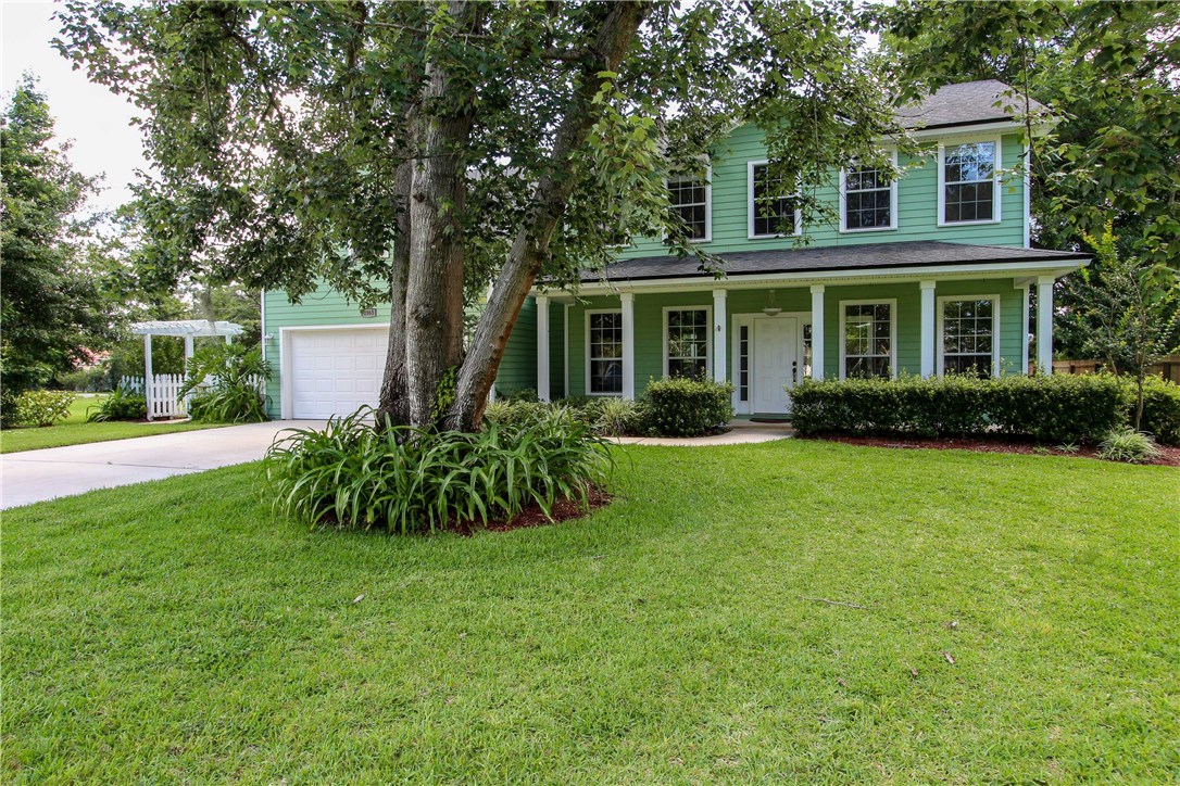 2965 Pinedale Road Fernandina Beach, FL 32034 - Photo 2 of 35 a front view of a house with a garden and yard