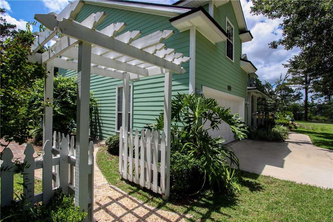 2965 Pinedale Road Fernandina Beach, FL 32034 - Photo 29 of 35 a view of a house with a small yard and floor to ceiling window