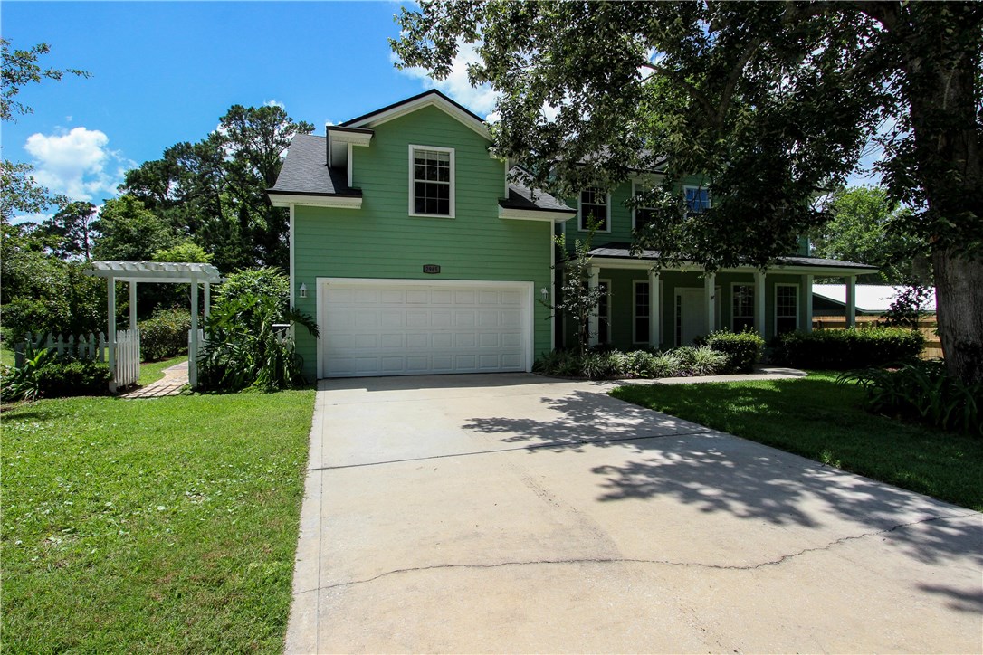 2965 Pinedale Road Fernandina Beach, FL 32034 - Photo 3 of 35 a front view of a house with a yard and garage