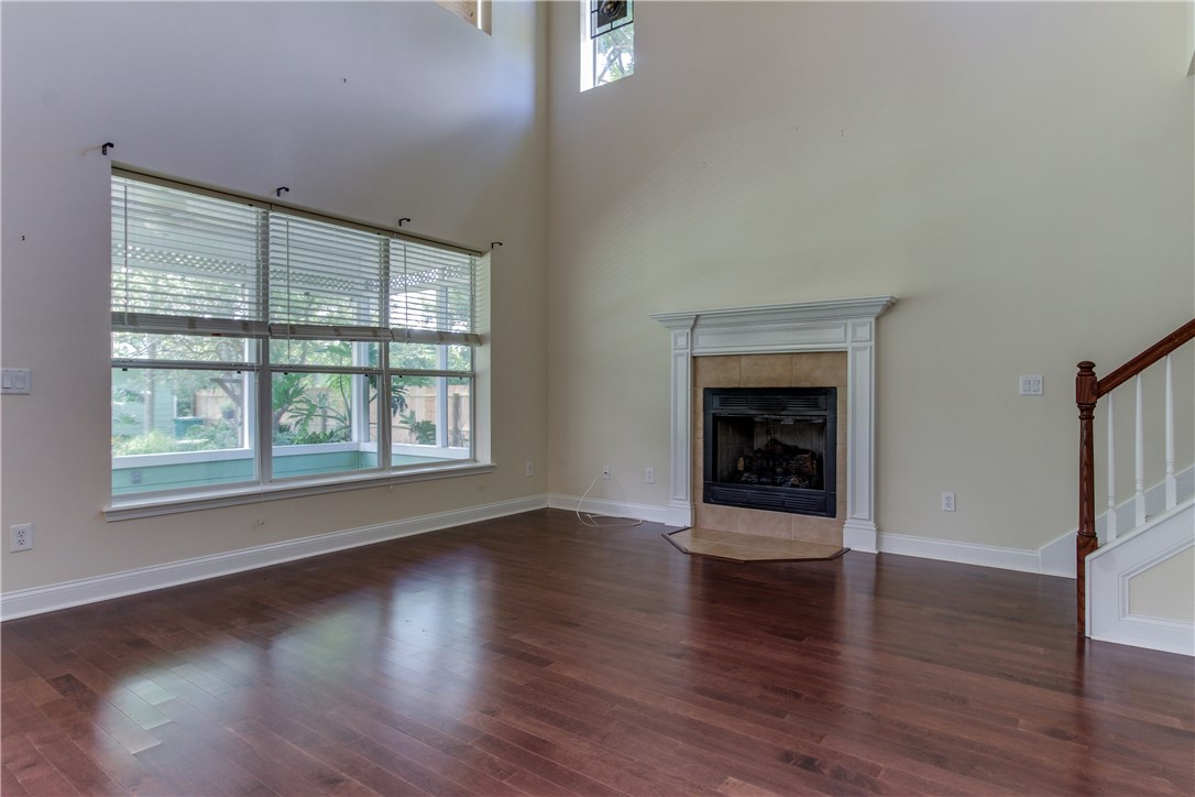 2965 Pinedale Road Fernandina Beach, FL 32034 - Photo 6 of 35 an empty room with wooden floor fireplace and windows