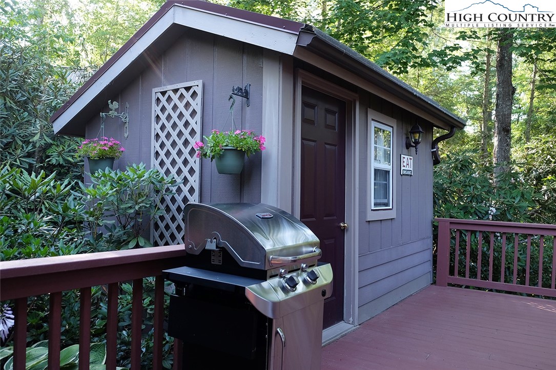 203 Black Pine Road Newland, NC 28657 - Photo 15 of 39 a view of a wooden house with a small yard and wooden fence