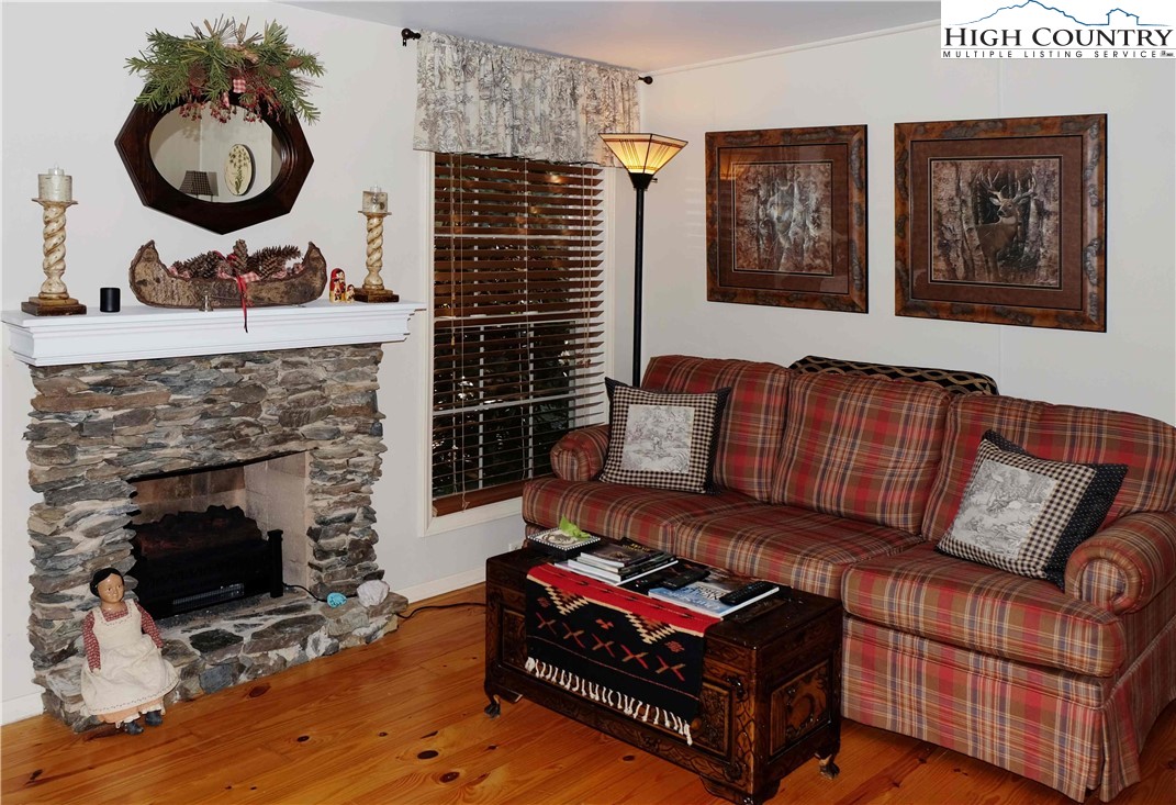 203 Black Pine Road Newland, NC 28657 - Photo 4 of 39 a living room with furniture and a fireplace