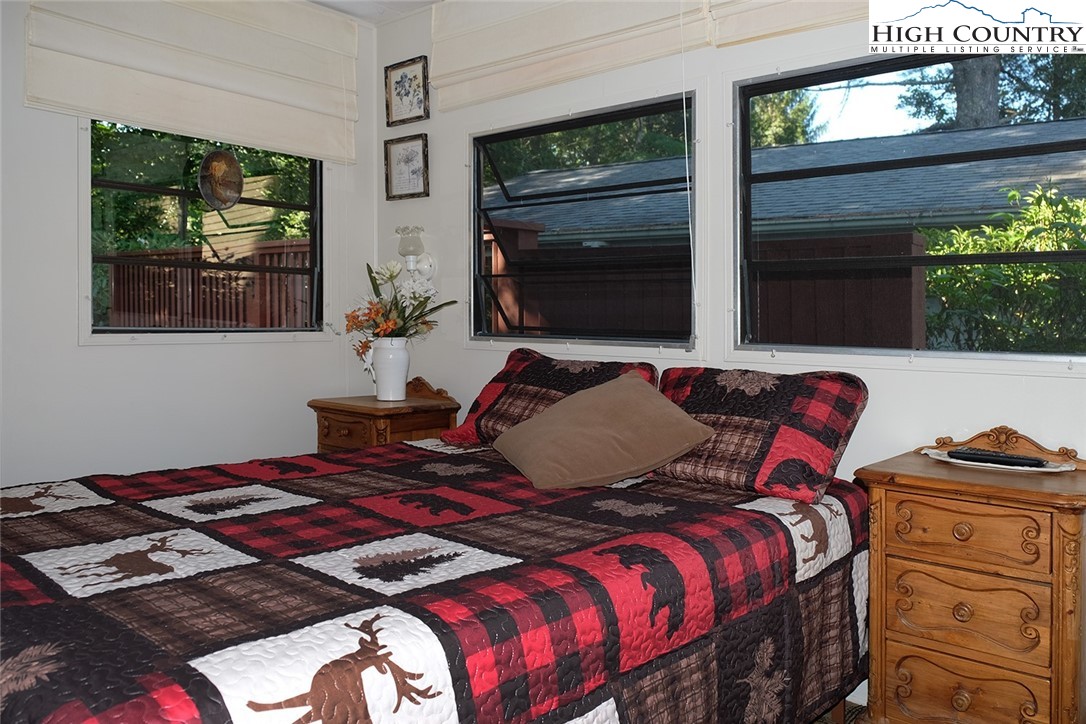 203 Black Pine Road Newland, NC 28657 - Photo 9 of 39 a bedroom with a bed and a window