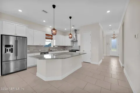a view of a kitchen with a sink and a stove top oven