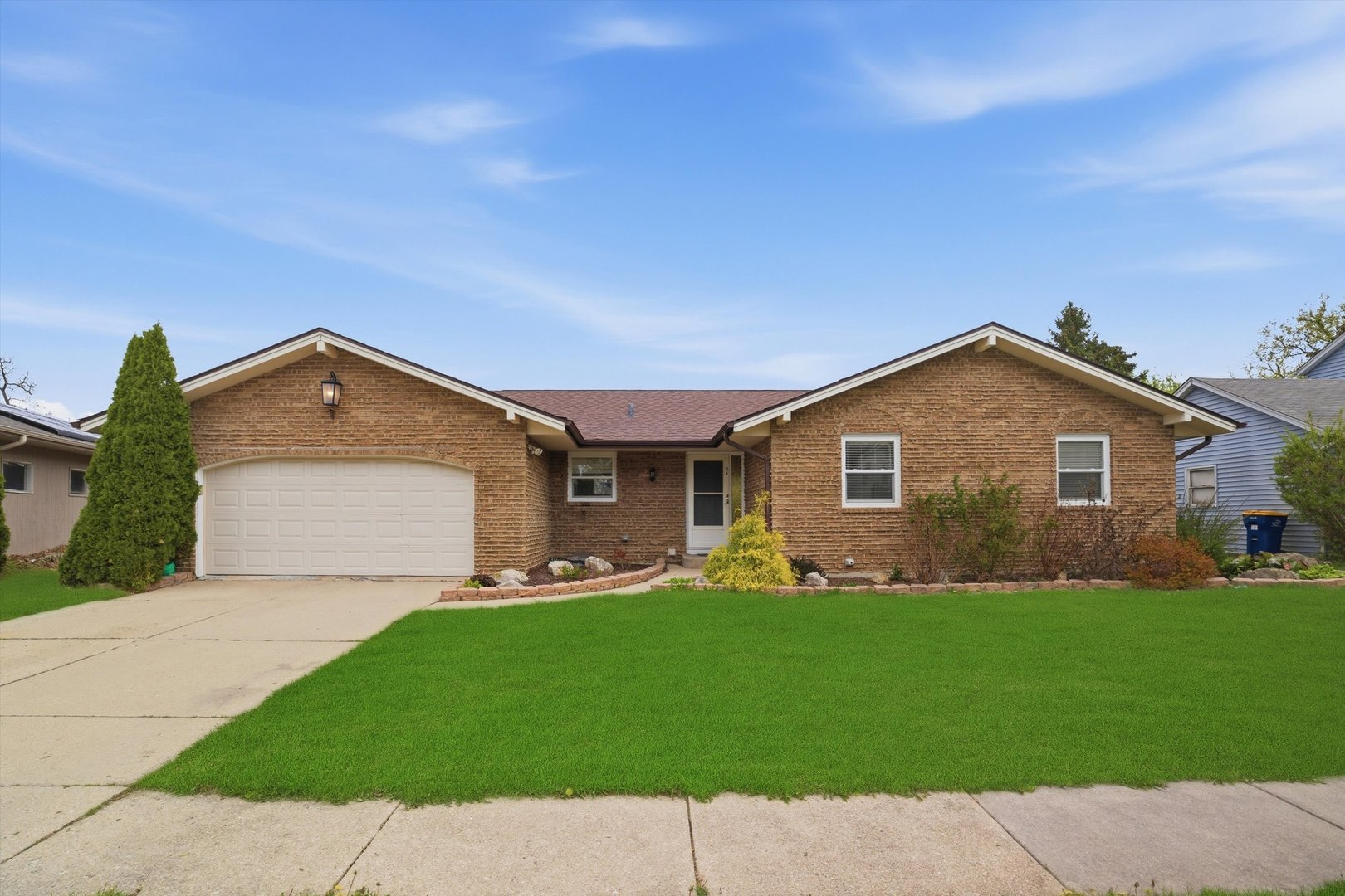 a front view of house with yard and garage