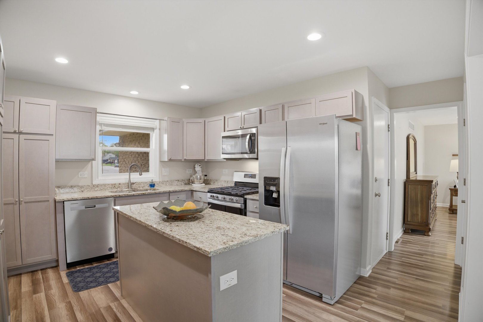 25 Devonshire Circle Elgin, IL 60123 - Photo 2 of 31 a kitchen with a sink a refrigerator a stove and white cabinets with wooden floor