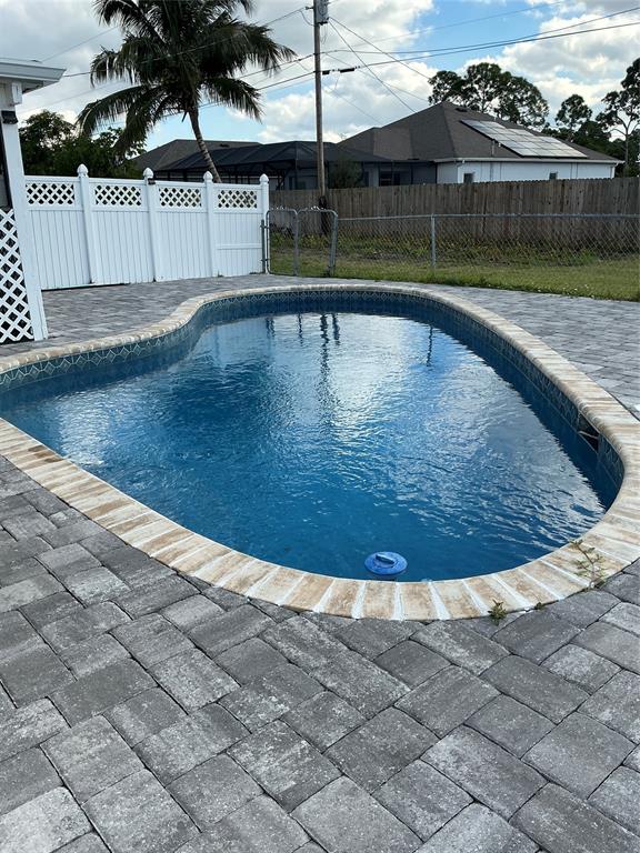 1858 Southwest Capehart Avenue Port St. Lucie, FL 34953 - Photo 2 of 11 a view of outdoor space swimming pool and lake view