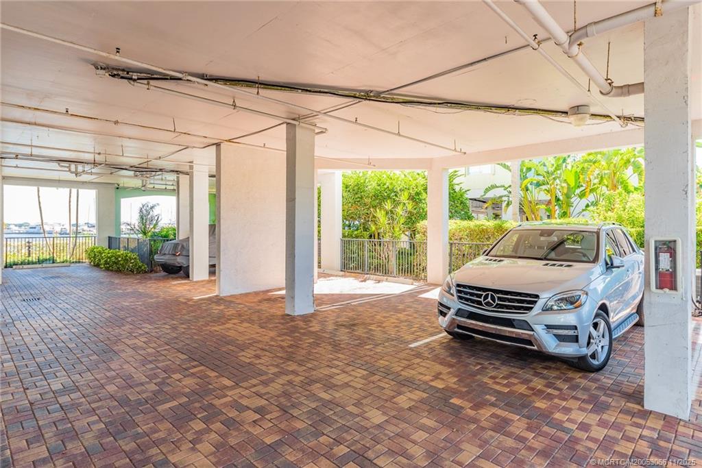 715 Northwest Flagler Avenue, Unit 202 Stuart, FL 34994 - Photo 11 of 26 a car parked in front of a house