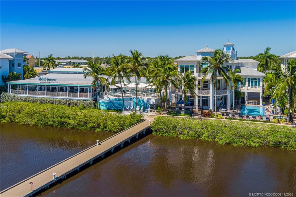 715 Northwest Flagler Avenue, Unit 202 Stuart, FL 34994 - Photo 14 of 26 a view of swimming pool with outdoor seating and lake view