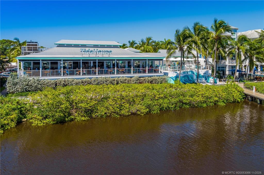715 Northwest Flagler Avenue, Unit 202 Stuart, FL 34994 - Photo 19 of 26 a front view of a house with a lake view