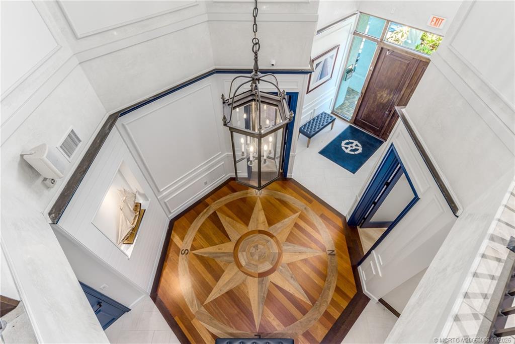 715 Northwest Flagler Avenue, Unit 202 Stuart, FL 34994 - Photo 22 of 26 a view of staircase with a table and a chair