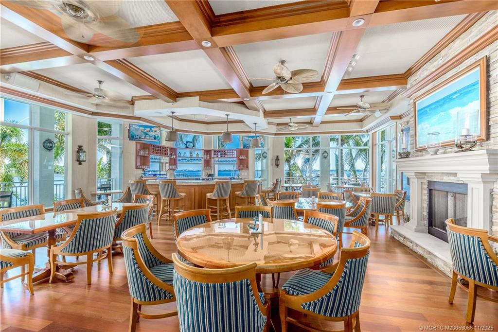 715 Northwest Flagler Avenue, Unit 202 Stuart, FL 34994 - Photo 24 of 26 a dining room with furniture window and wooden floor