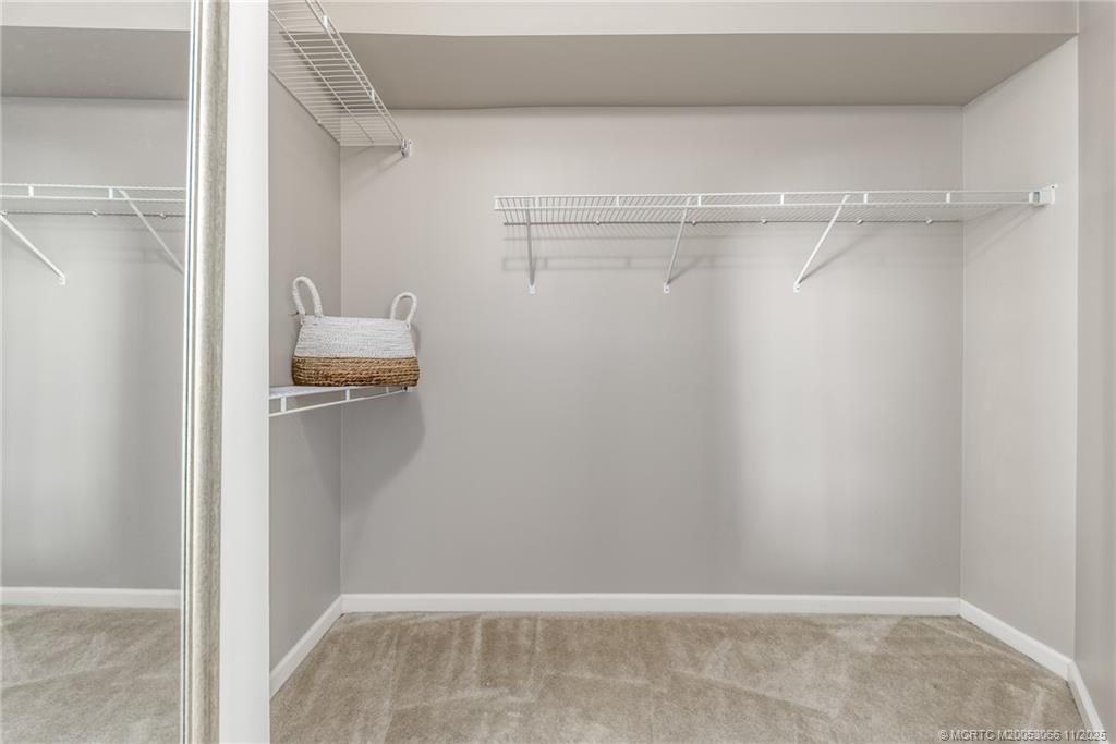 715 Northwest Flagler Avenue, Unit 202 Stuart, FL 34994 - Photo 7 of 26 a view of walk in closet with empty racks