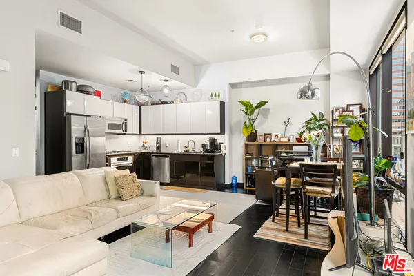 a living room with furniture kitchen view and a fireplace