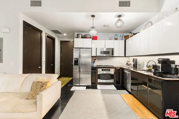 a kitchen with granite countertop a refrigerator and a sink