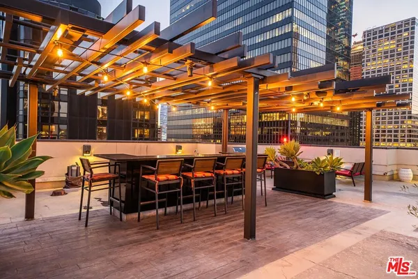 a view of a patio with dining table and chairs with wooden floor