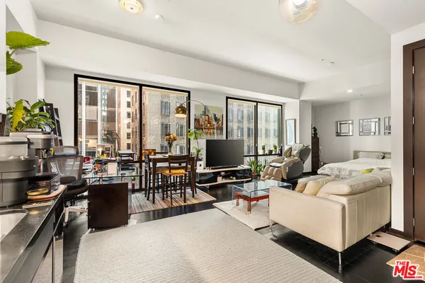 a living room with furniture large window and a table