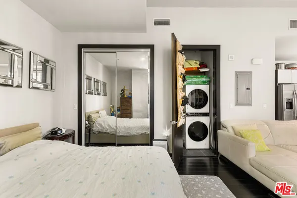 a bedroom with a bed and a couch