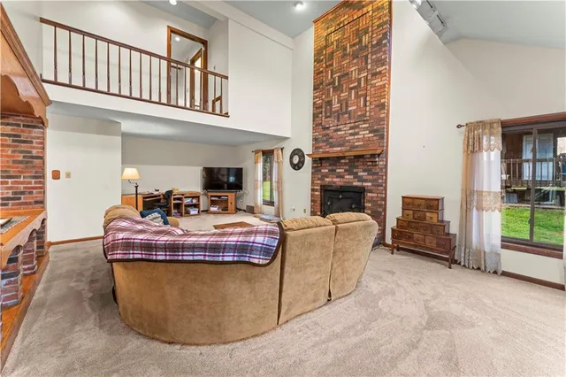 a living room with fireplace furniture and a floor to ceiling window