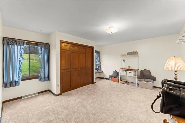 a view of a livingroom with furniture and a window