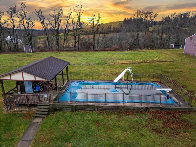 a aerial view of a house with a yard table and chairs