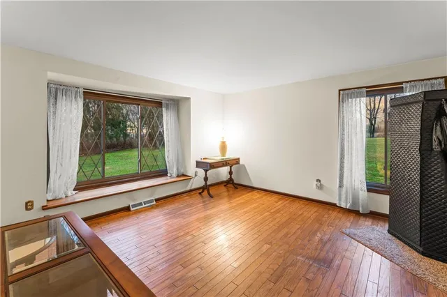 a view of a room with wooden floor and a window