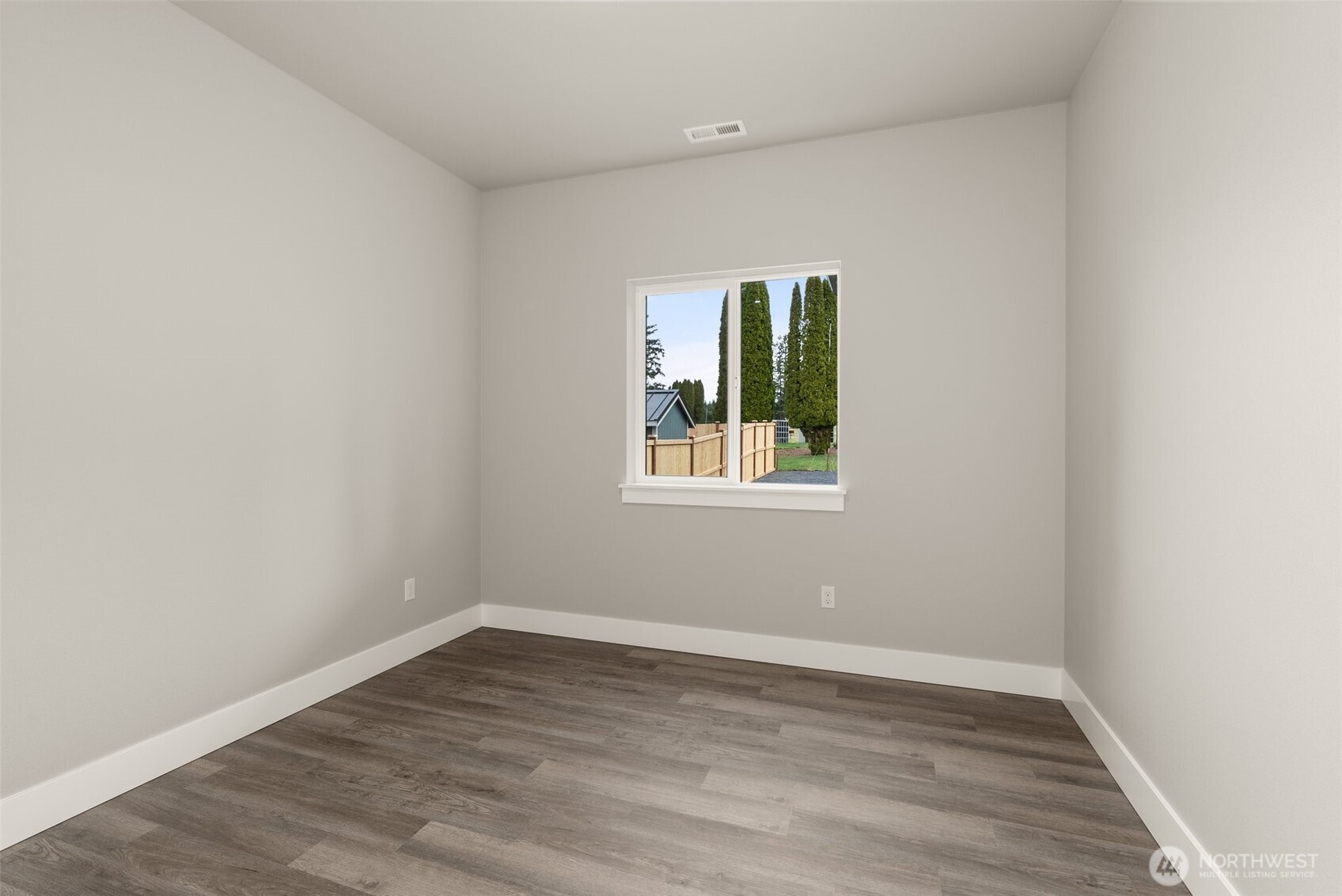 2103 Hawks Vw Lane Winlock, WA 98596 - Photo 15 of 24 a view of an empty room with wooden floor and a window