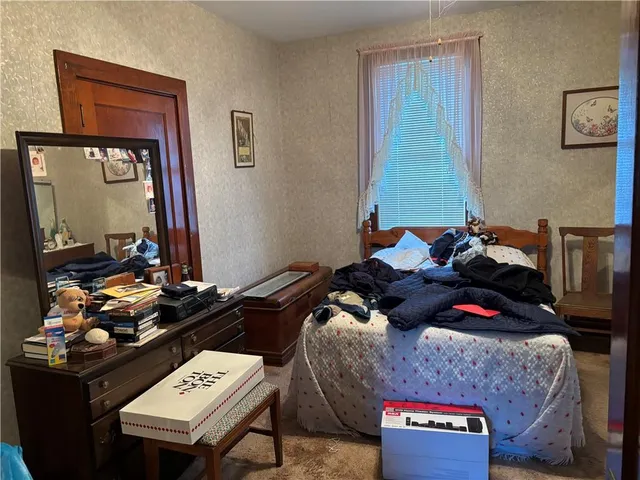 a living room with furniture and a mirror