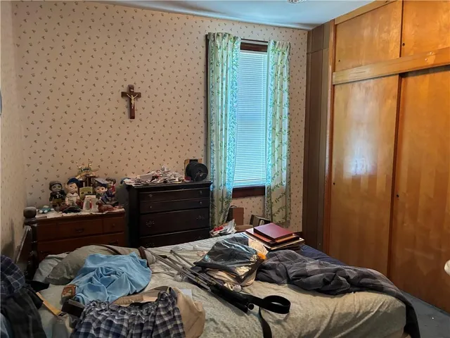 a bed room with a bed and a mirror