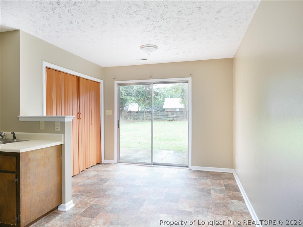 115 Eulon Loop, Unit A Raeford, NC 28376 - Photo 10 of 16 a view of a room with a sink and a window