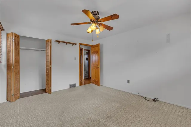 a view of a livingroom with a ceiling fan and window