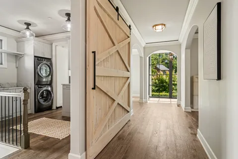 a view of a hallway view with wooden floor and staircase