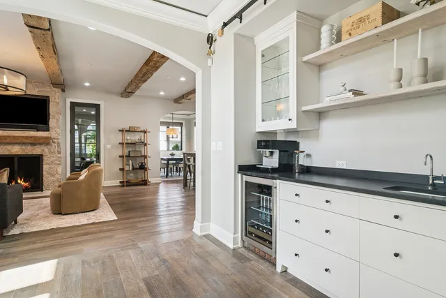 a large kitchen with cabinets wooden floor and stainless steel appliances