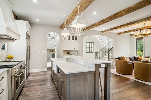 a dining room with furniture a chandelier and wooden floor