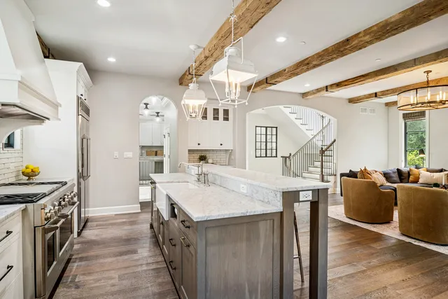 a dining room with furniture a chandelier and wooden floor