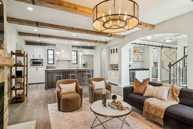 a spacious bedroom with a bed and a chandelier