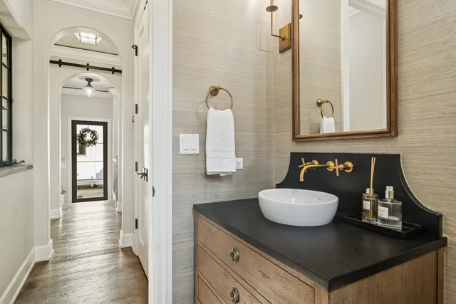 a spacious bathroom with a sink and a mirror