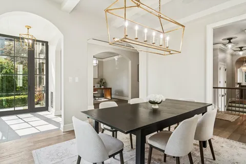 a view of a dining room with a table and chairs
