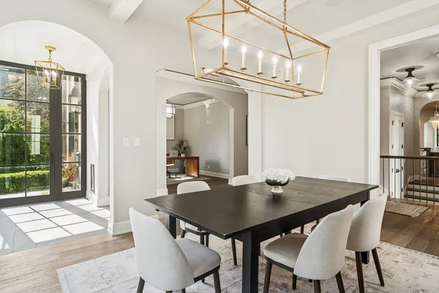 a view of a dining room with a table and chairs