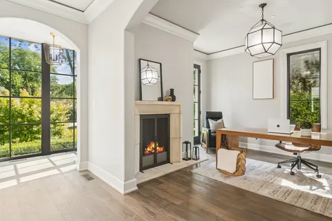 a view of a room with wooden floor furniture and windows