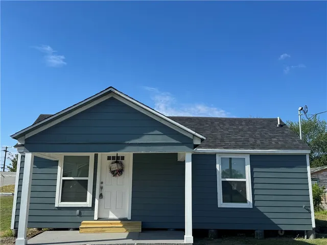 a backyard of a house with wooden deck