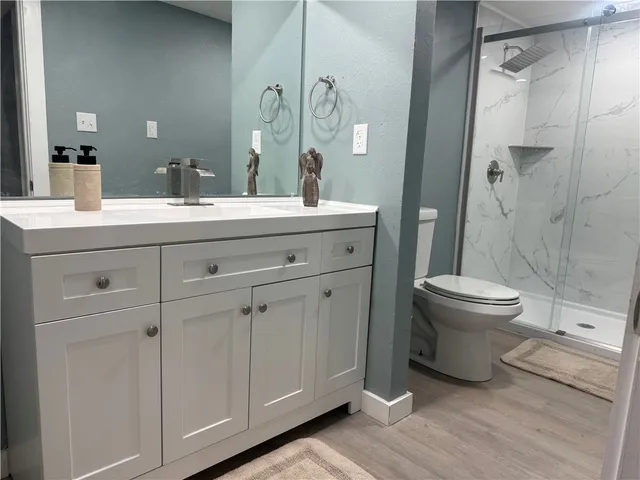 a bathroom with a double vanity sink mirror and toilet