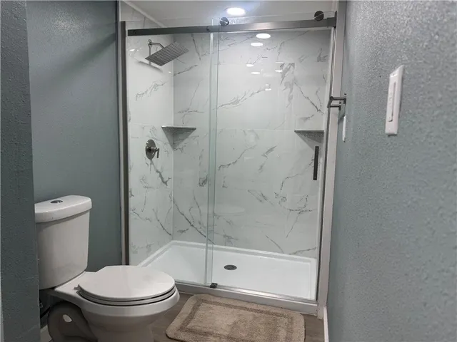 a bathroom with a shower and a toilet