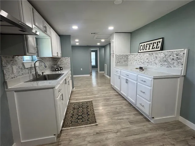 a kitchen with sink and cabinets