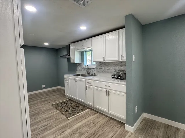 a kitchen with stainless steel appliances granite countertop a sink stove and cabinets