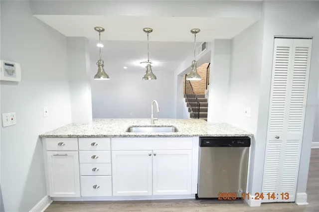 a bathroom with a granite countertop double vanity sink and a mirror